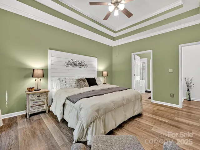 a bedroom with bed and a chandelier