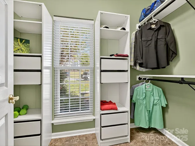 a view of walk in closet and bathroom