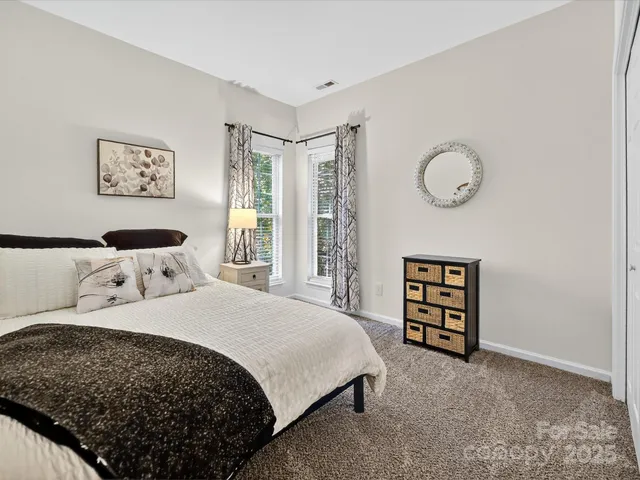 a bedroom with a bed a wall painting and a closet