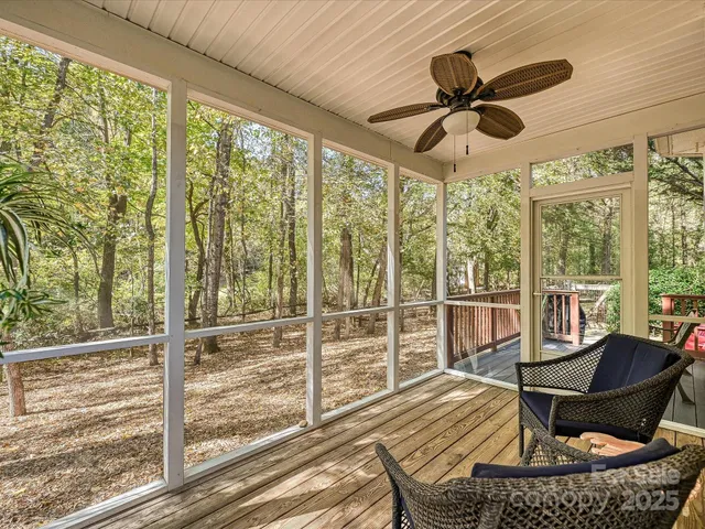 a view of a deck with couches with wooden floor and fence