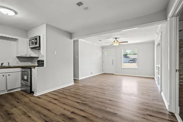 wooden floor in an empty room and a sink