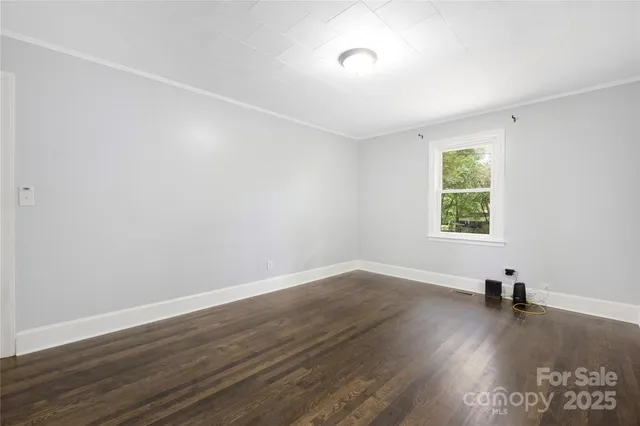 a view of a room with wooden floor and windows
