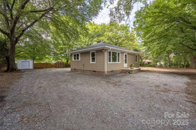 a front view of house with yard and trees
