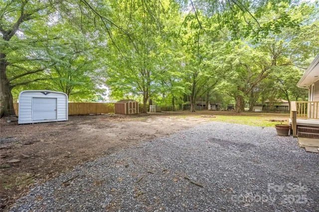 a view of a backyard with swimming pool