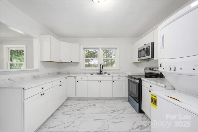 a kitchen that has a sink and a stove in it