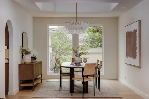 a kitchen with a sink window and cabinets