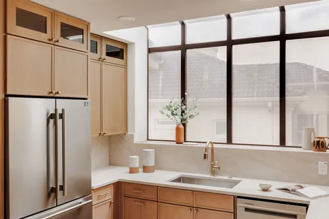 a kitchen with stainless steel appliances granite countertop a sink and cabinets