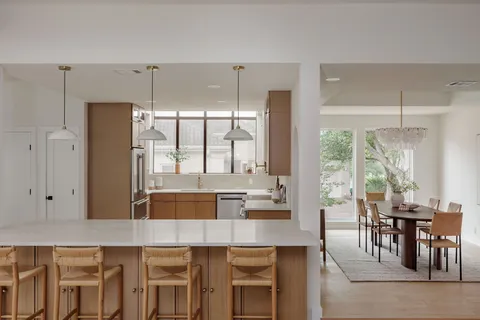a kitchen with a table chairs and entryway