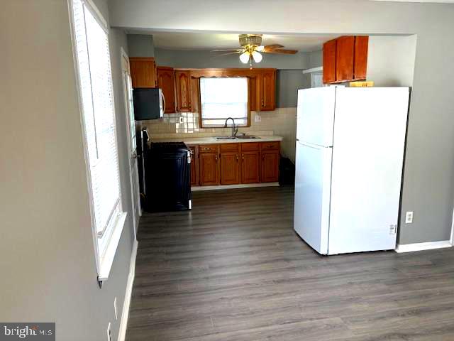 50 Gerard Road Hamilton, NJ 08620 - Photo 12 of 19 a kitchen with a refrigerator sink and wooden floor