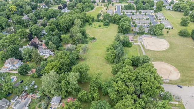 an aerial view of a house with a yard and lake view