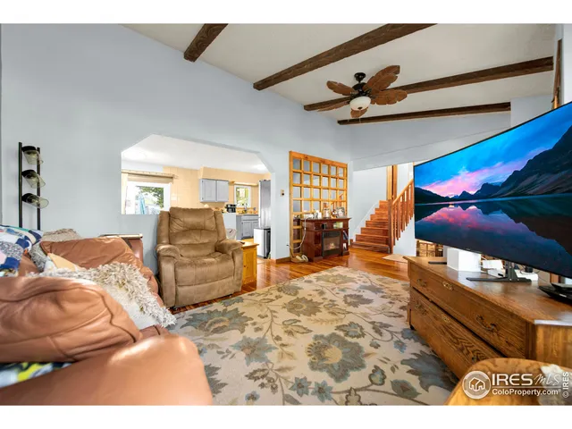 a bedroom with furniture and flat screen tv