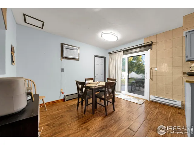 a dining room with furniture and wooden floor