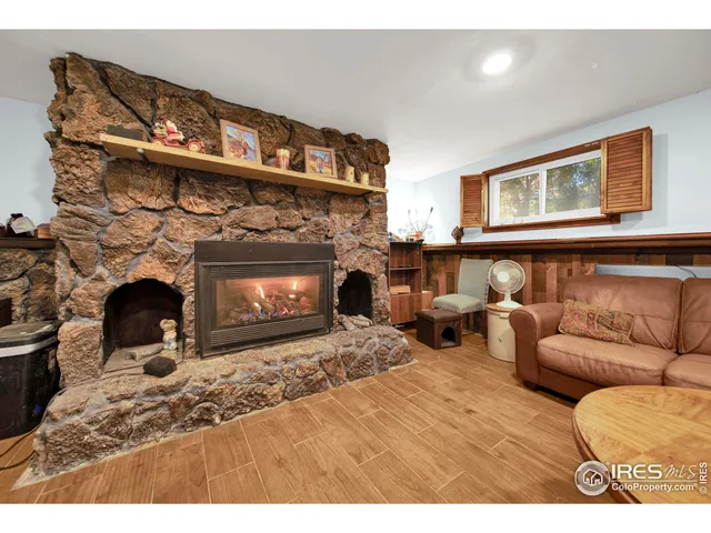 a living room with furniture a fireplace and windows