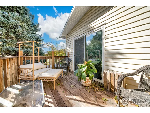 a view of a patio with a dining table and chairs with wooden floor