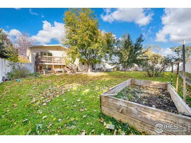 a view of a backyard with wooden fence