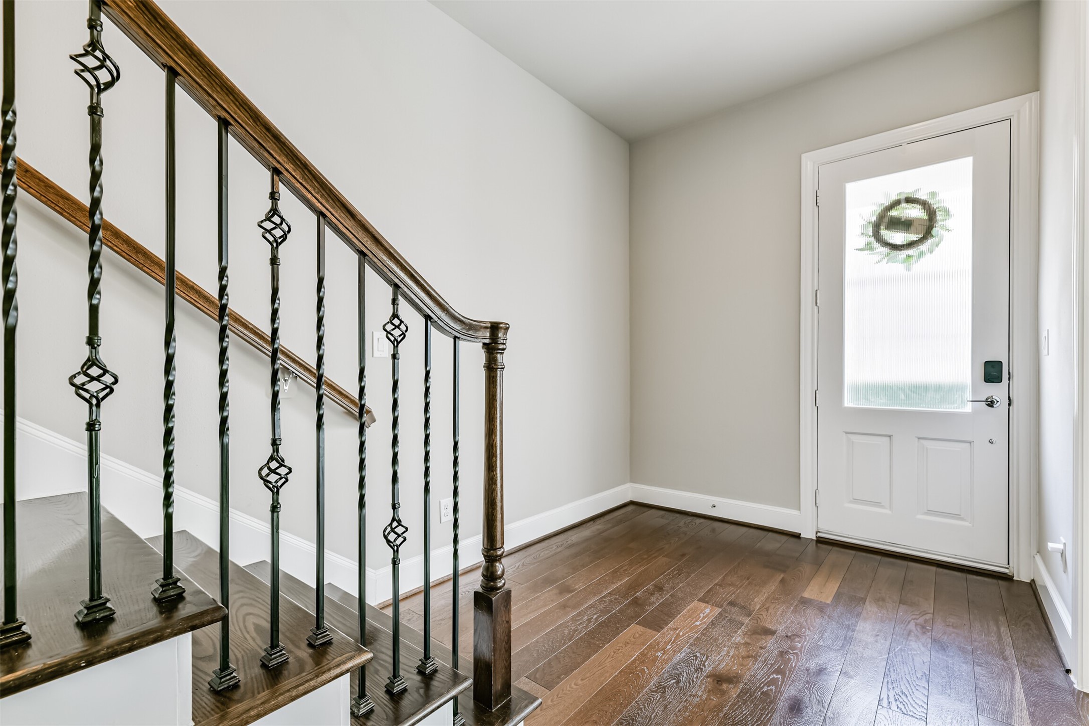 9507 London Bridge Station Houston, TX 77045 - Photo 7 of 32 a view of an entryway with wooden floor and stairs