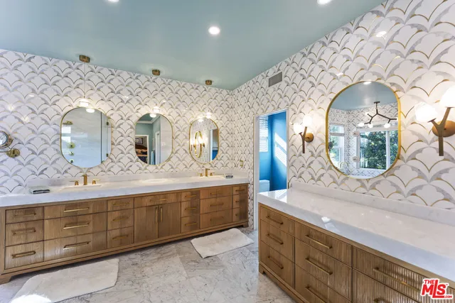 a spacious bathroom with a double vanity sink and a mirror