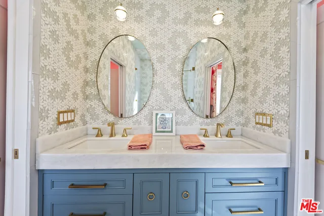 a bathroom with a double vanity sink and a mirror