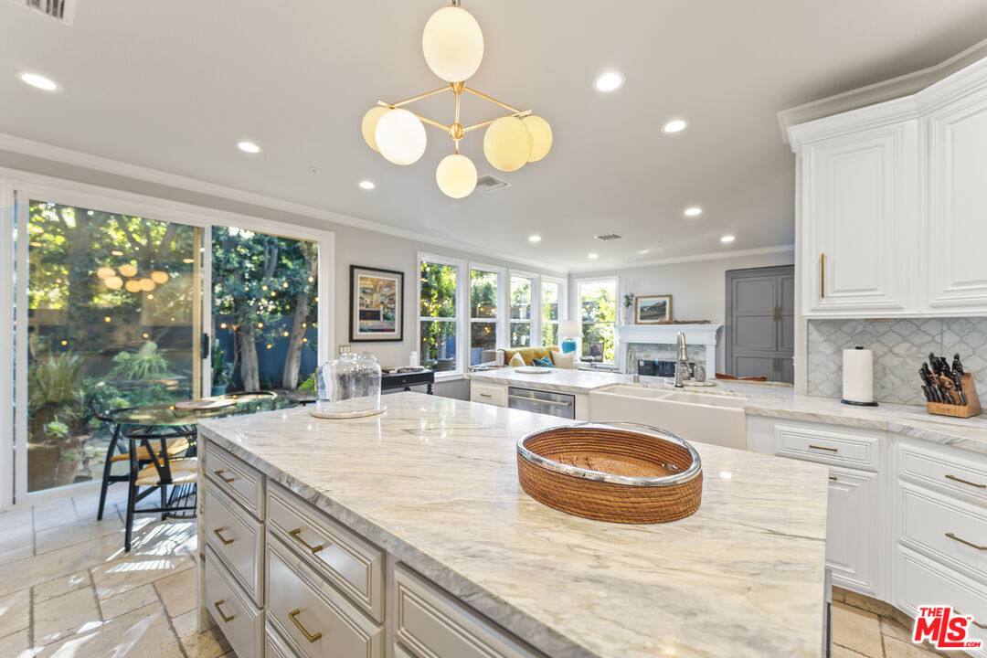 6738 Andover Lane Los Angeles, CA 90045 - Photo 7 of 24 a large kitchen with kitchen island a large window cabinets and stainless steel appliances