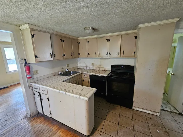 a kitchen with a stove a sink and a refrigerator