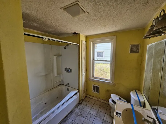 a bathroom with a tub and a shower