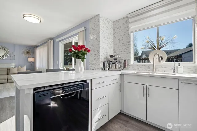 a kitchen with white cabinets and a sink