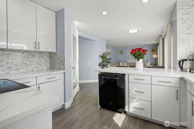 a kitchen with white cabinets and appliances