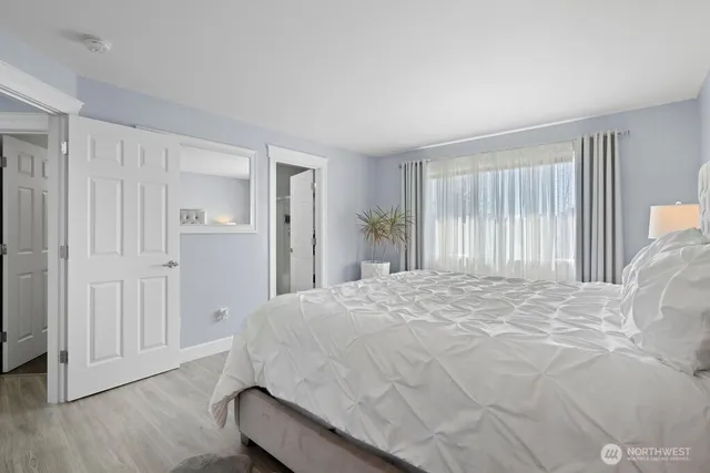 a spacious bedroom with a bed and a window