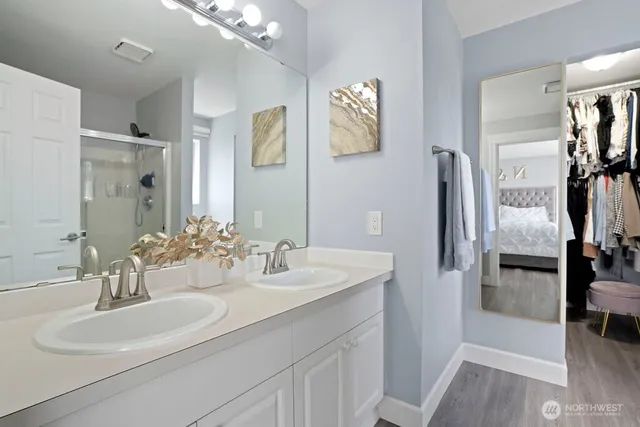 a bathroom with a sink double vanity and shower