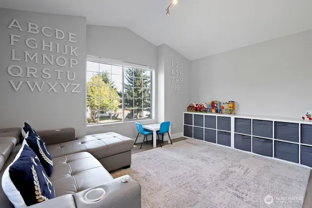 a bedroom with furniture and a large window