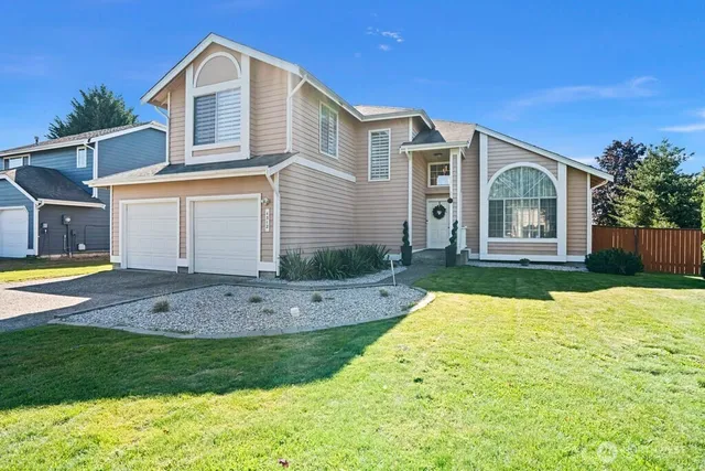 a front view of a house with garden