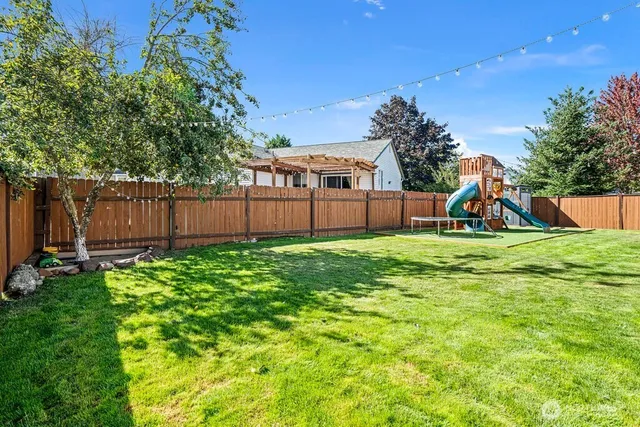 a view of a backyard with a garden and entertaining space