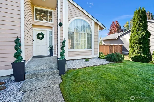 a front view of a house with garden