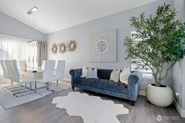 a living room with furniture and a potted plant