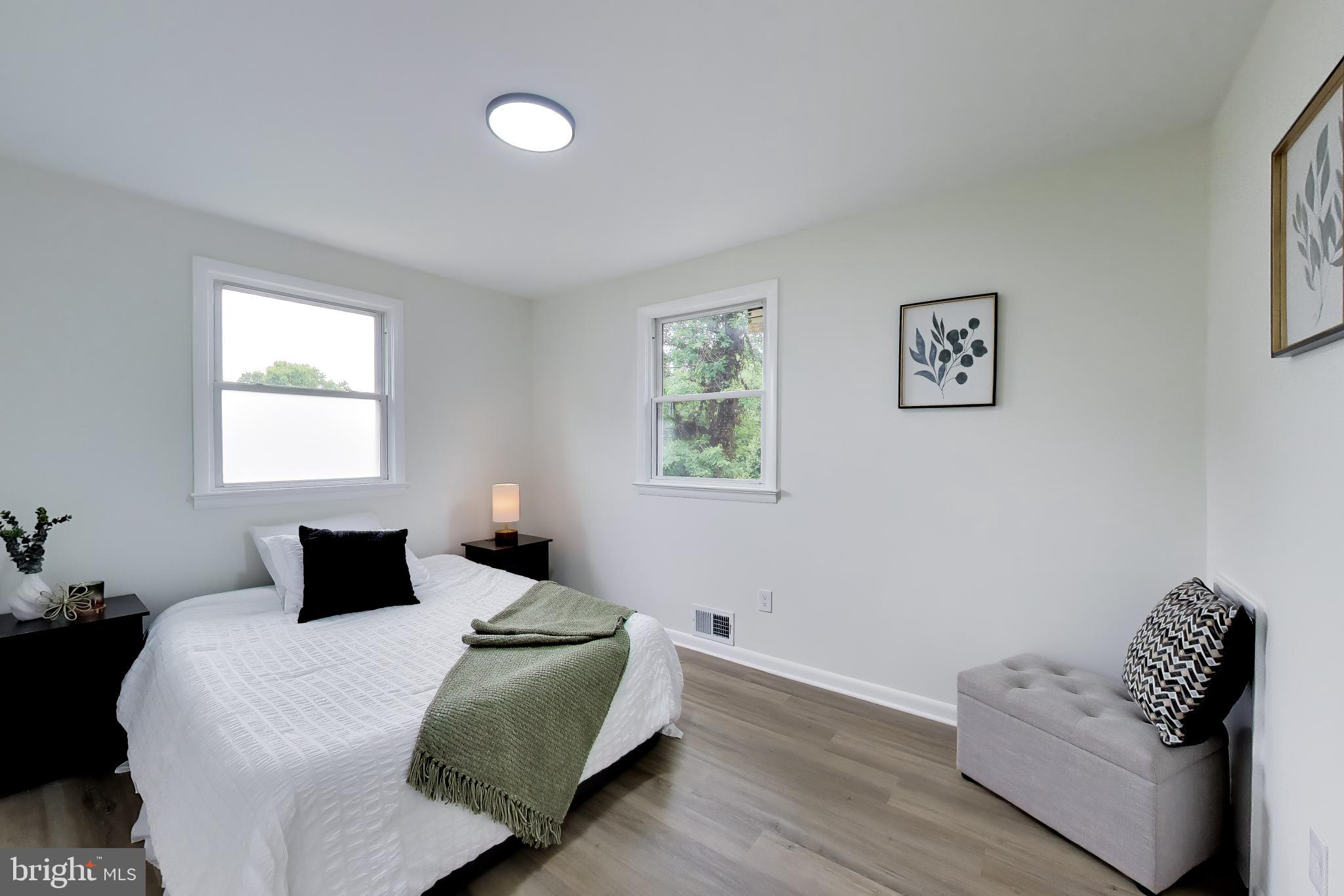 11309 Keystone Avenue Clinton, MD 20735 - Photo 11 of 36 a bedroom with bed window and couch
