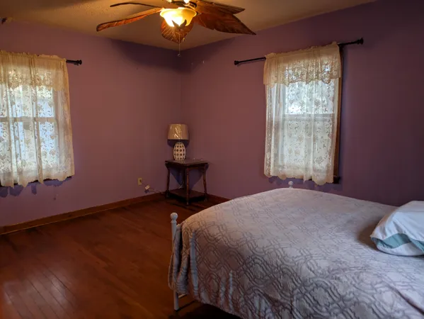 a bedroom with a bed and window