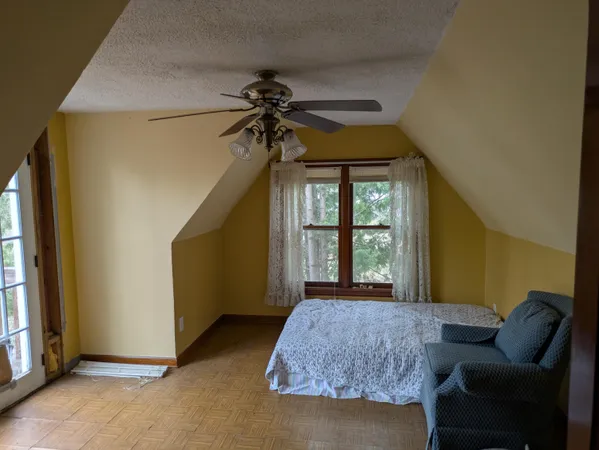 a bedroom with a bed and a couch