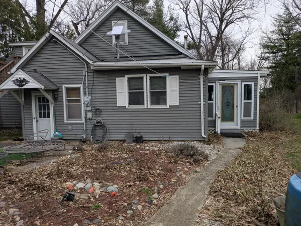 a front view of a house with trees