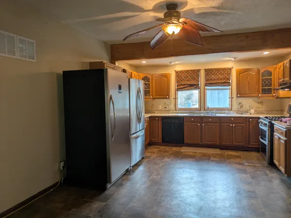 a kitchen with stainless steel appliances a sink and a refrigerator