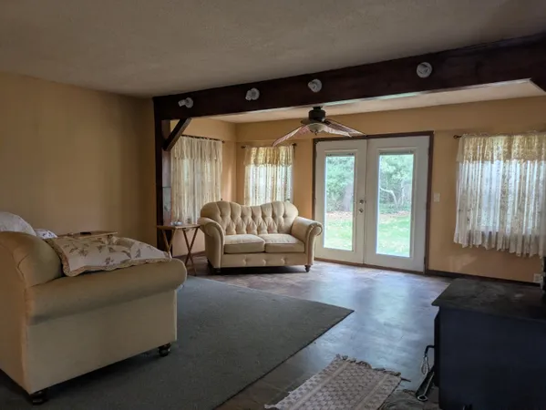 a living room with furniture and a large window