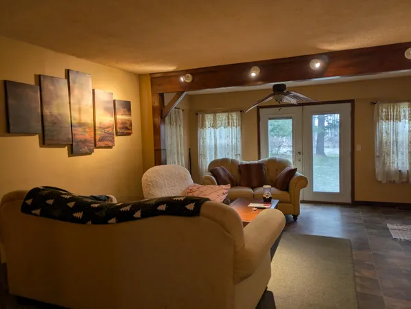 a living room with furniture and large windows
