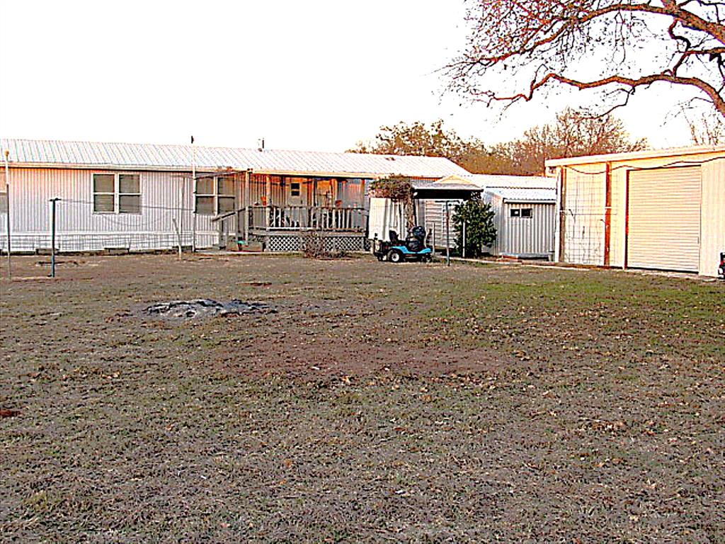 3231 Portside Drive May, TX 76857 - Photo 19 of 26 a big house with a big yard and large trees