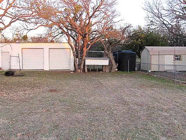 3231 Portside Drive May, TX 76857 - Photo 21 of 26 a view of a house with a large tree and a yard