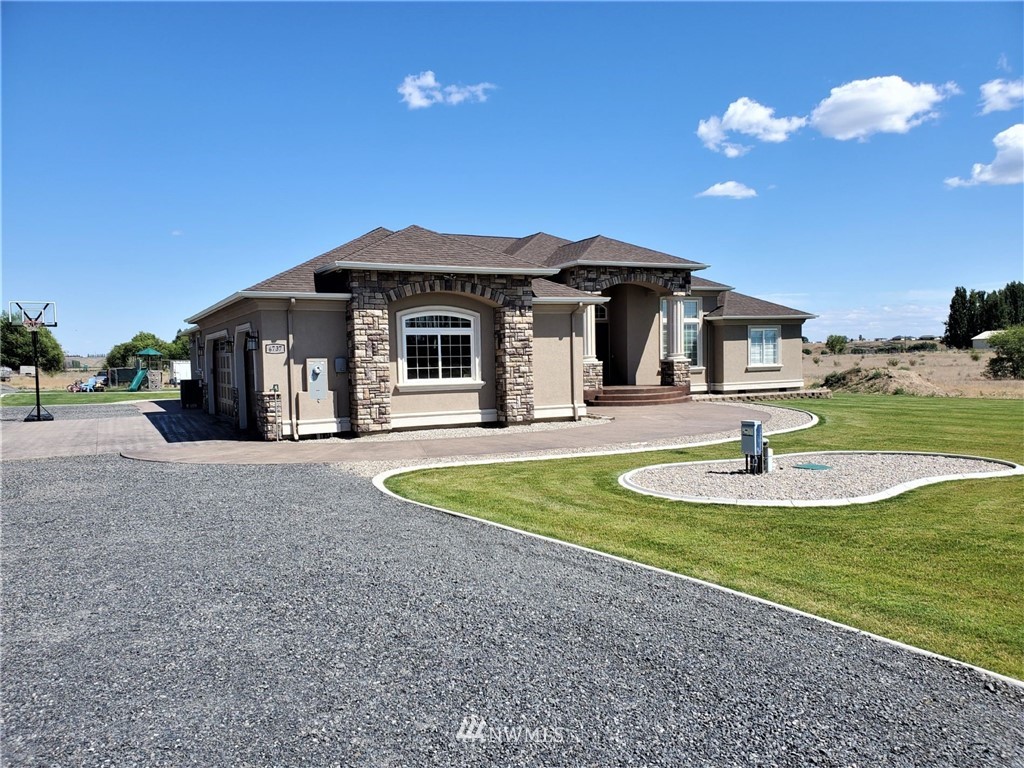 6737 Rd D.8 Northeast Moses Lake, WA 98837 - Photo 1 of 24 a front view of a house with swimming pool