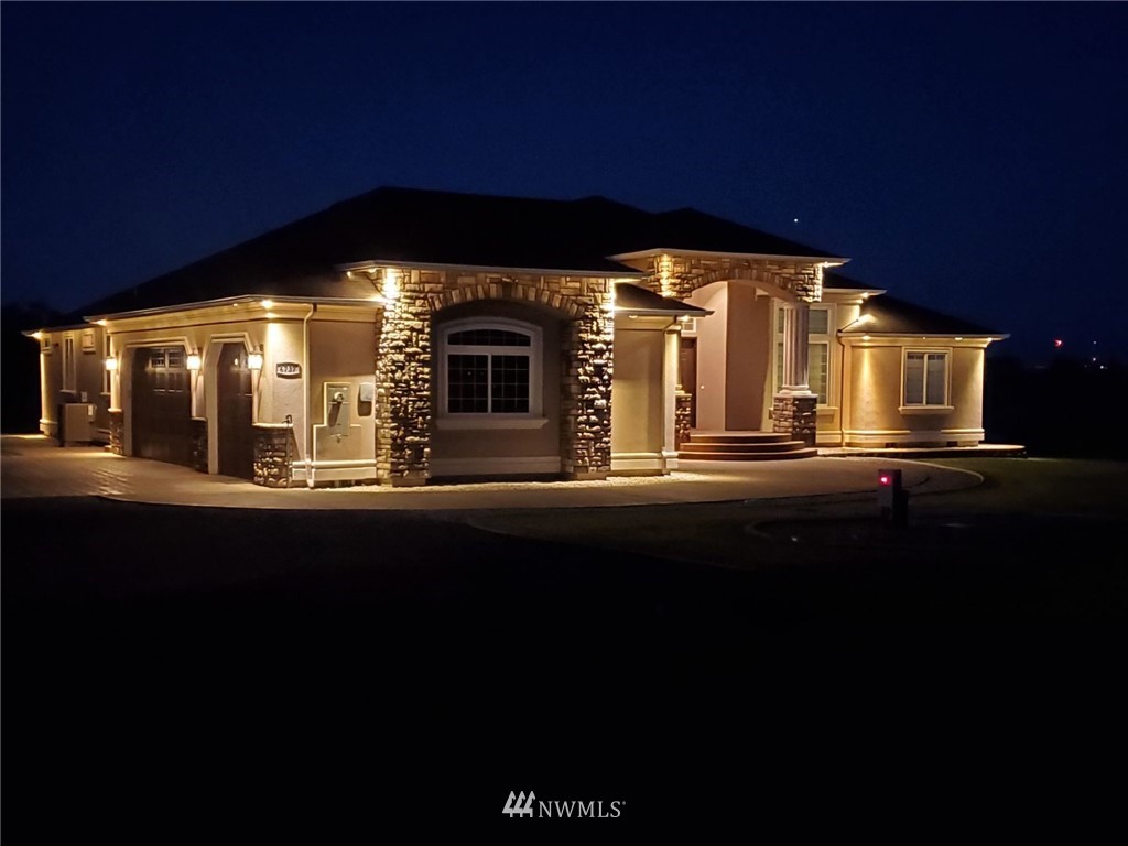 6737 Rd D.8 Northeast Moses Lake, WA 98837 - Photo 2 of 24 a front view of a house with a floor to ceiling window and brick wall