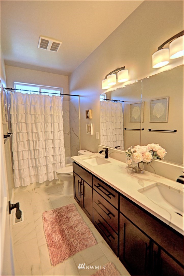 6737 Rd D.8 Northeast Moses Lake, WA 98837 - Photo 19 of 24 a bathroom with a double vanity sink and a mirror