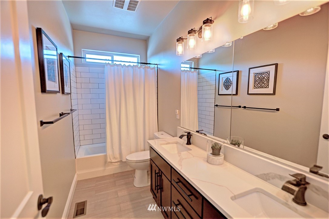 6737 Rd D.8 Northeast Moses Lake, WA 98837 - Photo 21 of 24 a bathroom with a double vanity sink a mirror and a shower