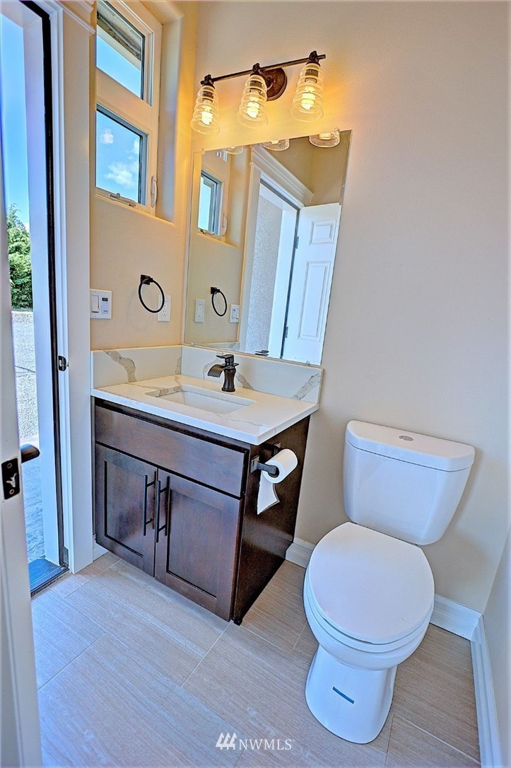 6737 Rd D.8 Northeast Moses Lake, WA 98837 - Photo 24 of 24 a bathroom with a toilet a sink and mirror
