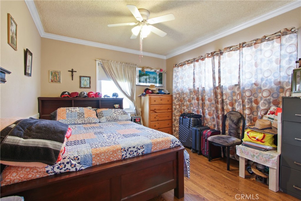 618 East 225th Street Carson, CA 90745 - Photo 11 of 14 a bedroom with a bed and wooden floor
