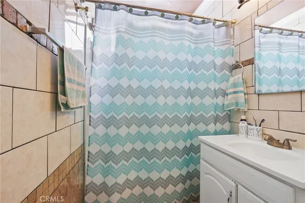 a bathroom with a sink and shower curtain